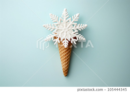 Ice cream cone with Christmas decoration snowflake greeting card. Minimal Christmas or New Year winter holidays concept. Waffle cone and snow flakes, summer meets winter. Flat Lay Ice cream cone with Christmas decoration snowflake greeting card. Minimal Christmas or New Year winter holidays concept. Waffle cone and snow flakes, summer meets winter. Flat Lay 105444345