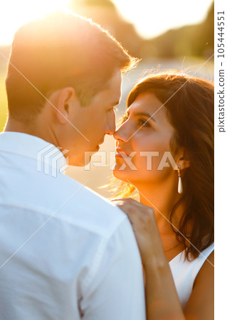 Lovely wedding couple at sunset. Bride, groom in wedding attire with bouquet of flowers. Romantic. 105444551