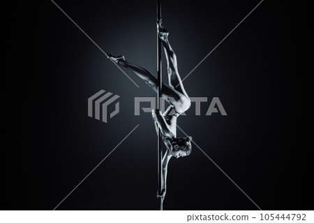 Young woman pole dancing 105444792