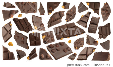 Slices of dark chocolate with nuts on a white isolated background. A set of chocolate that scatters in different directions with nuts of different sizes. Chocolate isolate for advertising banner. Slices of dark chocolate with nuts on a white isolated background. A set of chocolate that scatters in different directions with nuts of different sizes. Chocolate isolate for advertising banner. 105444934