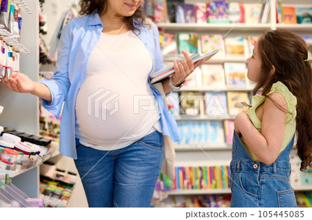Mother and daughter in school stationery shop, buying school supplies, enjoying a shopping day together. Back to school 105445085