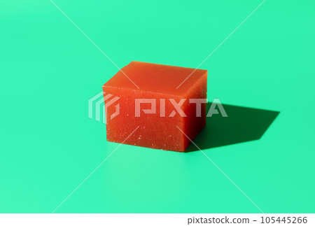 Quince marmalade cube isolated on a green background Quince marmalade cube isolated on a green background 105445266