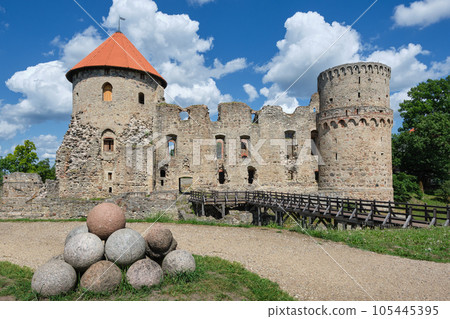 Latvian tourist landmark attraction - ruins of the medieval castle, stone walls and towers in Cesis town, Latvia. 105445395