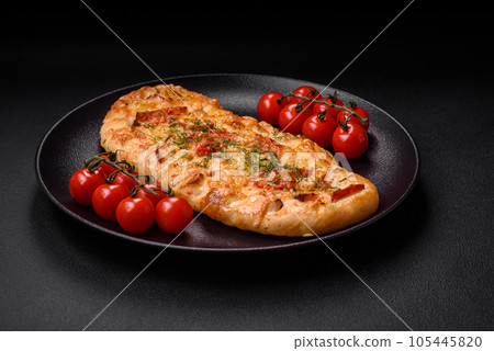 Delicious oven fresh flatbread pizza with cheese, tomatoes, sausage, salt and spices Delicious oven fresh flatbread pizza with cheese, tomatoes, sausage, salt and spices 105445820