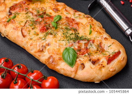 Delicious oven fresh flatbread pizza with cheese, tomatoes, sausage, salt and spices Delicious oven fresh flatbread pizza with cheese, tomatoes, sausage, salt and spices 105445864