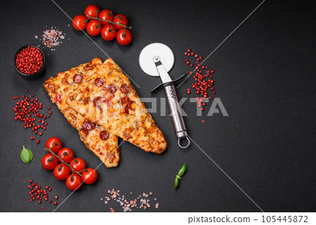 Delicious oven fresh flatbread pizza with cheese, tomatoes, sausage, salt and spices 105445872