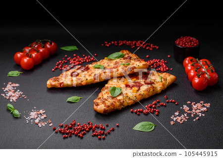 Delicious oven fresh flatbread pizza with cheese, tomatoes, sausage, salt and spices 105445915