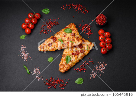 Delicious oven fresh flatbread pizza with cheese, tomatoes, sausage, salt and spices 105445916