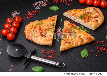 Delicious oven fresh flatbread pizza with cheese, tomatoes, sausage, salt and spices 105445920
