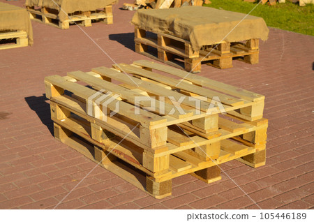 Wooden pallets are placed on the track in pairs to be used as benches. Wooden pallets are placed on the track in pairs to be used as benches. 105446189