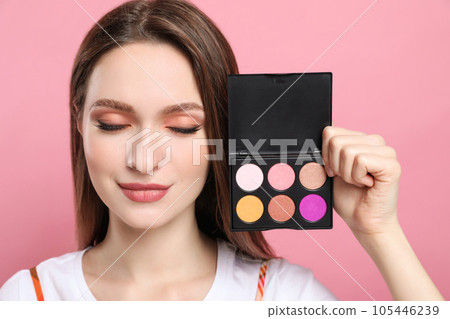 Beauty blogger with eyeshadow palette on pink background Beauty blogger with eyeshadow palette on pink background 105446239