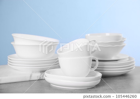Set of clean tableware on grey table Set of clean tableware on grey table 105446260