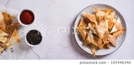 Spicy chips with paprika and dill from tortilla on a plate top view web banner Spicy chips with paprika and dill from tortilla on a plate top view web banner 105446340