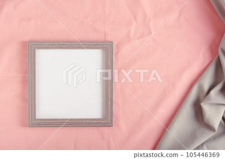Blank photo frame template on pink cotton fabric top view Blank photo frame template on pink cotton fabric top view 105446369
