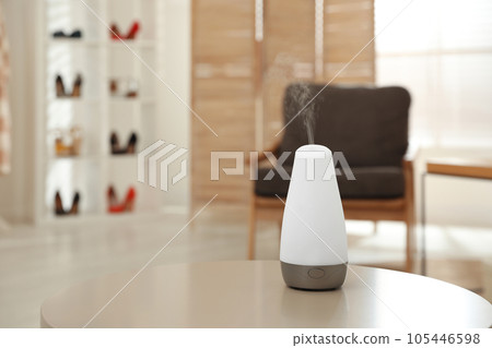 Aroma oil diffuser on table indoors, space for text. Air freshener Aroma oil diffuser on table indoors, space for text. Air freshener 105446598