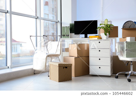Cardboard boxes and packed belongings in office. Moving day 105446602
