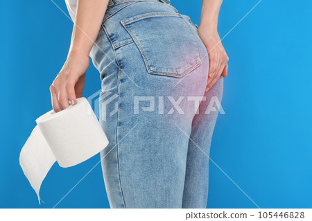 Woman with toilet paper suffering from hemorrhoid on light blue background, closeup Woman with toilet paper suffering from hemorrhoid on light blue background, closeup 105446828