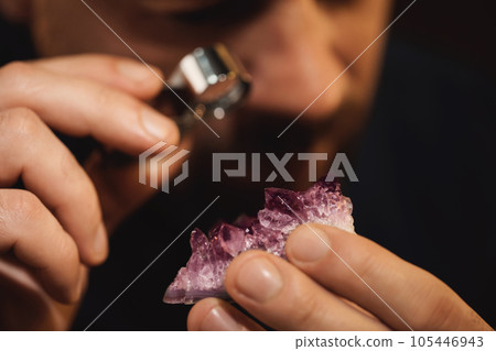 Jeweler working with gemstone on blurred background, closeup Jeweler working with gemstone on blurred background, closeup 105446943