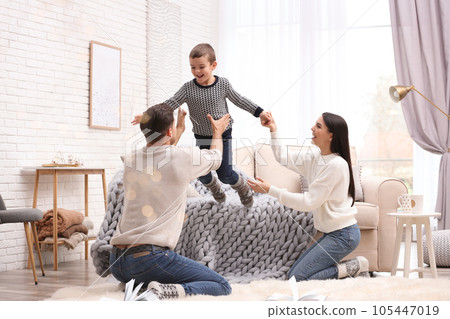 Happy family with little son having fun at home. Winter vacation 105447019
