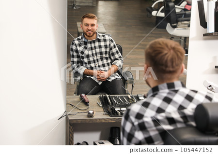 Young business owner in his barber shop 105447152