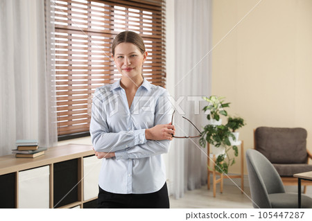 Professional psychotherapist with glasses in modern office 105447287