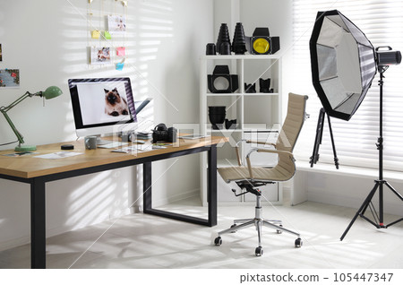Photographer's workplace with professional camera and computer in office 105447347
