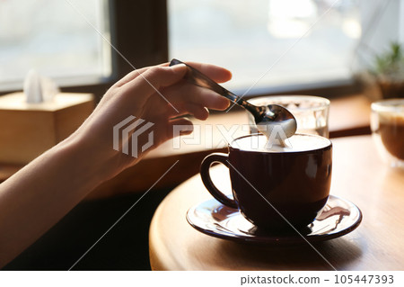 Woman with aromatic coffee at table in cafe, closeup Woman with aromatic coffee at table in cafe, closeup 105447393