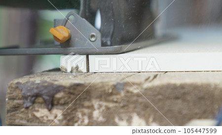 smooth movements with the saw along the marked cutting line on the chipboard. smooth movements with the saw along the marked cutting line on the chipboard. 105447599