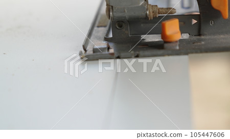 smooth movements with the saw along the marked cutting line on the chipboard. smooth movements with the saw along the marked cutting line on the chipboard. 105447606