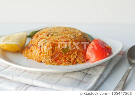 bulgur rice with tomato on a plate , 105447808