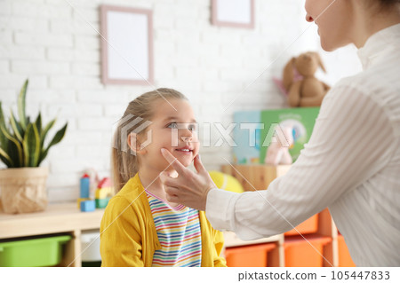 Speech therapist working with little girl in office Speech therapist working with little girl in office 105447833