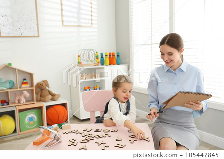 Speech therapist working with little girl in office Speech therapist working with little girl in office 105447845