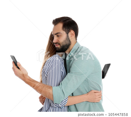 Couple addicted to smartphones hugging on white background. Relationship problems 105447858