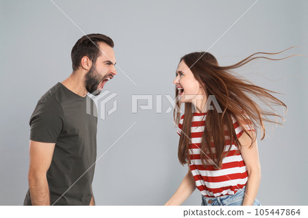 Couple quarreling on grey background. Relationship problems 105447864
