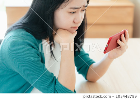 Young woman watching video on smartphone Young woman watching video on smartphone 105448789