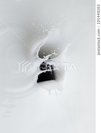 Cosmetic container white lotion droplet fly splashing. Milk lotion pour float to cosmetic bottle. Moisturizer lotion explosion spill. White background isolated high speed shutter freeze top view Cosmetic container white lotion droplet fly splashing. Milk lotion pour float to cosmetic bottle. Moisturizer lotion explosion spill. White background isolated high speed shutter freeze top view 105449263