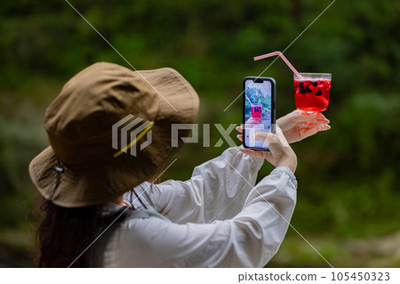 Young woman having a nice drink outdoors 105450323