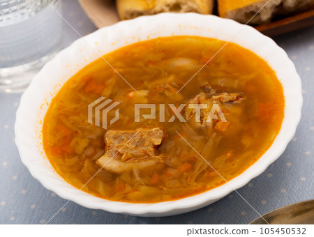 Russian-style cabbage soup Shchi of pork broth with boiled vegetables Russian-style cabbage soup Shchi of pork broth with boiled vegetables 105450532