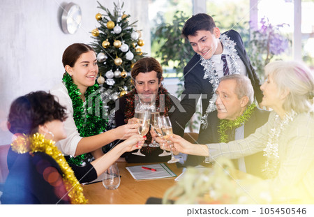 Cheerful colleagues enjoying New Year corporate party in office Cheerful colleagues enjoying New Year corporate party in office 105450546