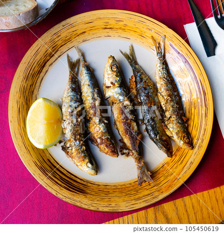 Fried sardines with lemon and parsley Fried sardines with lemon and parsley 105450619