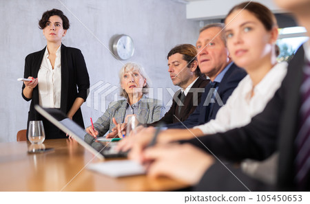 Latin American woman presenting business strategy to partners in office 105450653