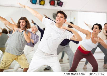 Group of adult people practices dance aerobics Group of adult people practices dance aerobics 105451167