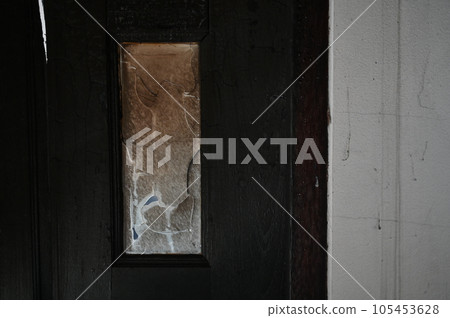 burn dirty black wood door with broken glass texture background 105453628
