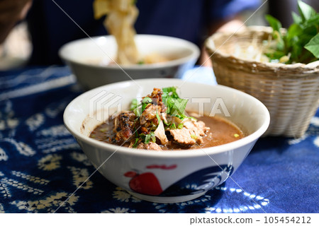 Rice noodles soup with pork and vegetables, Thai boat noodles style 105454212