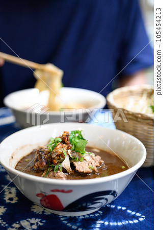Rice noodles soup with pork and vegetables, Thai boat noodles style 105454213
