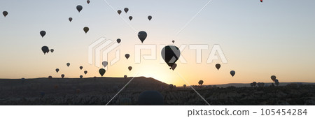 Many hot air balloons flying in sunset sky at Cappadocia, Turkey. Many hot air balloons flying in sunset sky at Cappadocia, Turkey. 105454284
