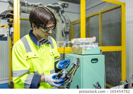 Male technician engineer checking parts automation robotics at industrial modern factory. 105454782