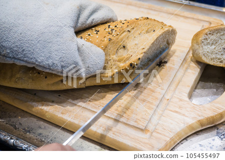 Fresh various bread slice and cutting knife on wooden table 105455497