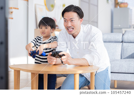 Boy and dad enjoying video games 105457240