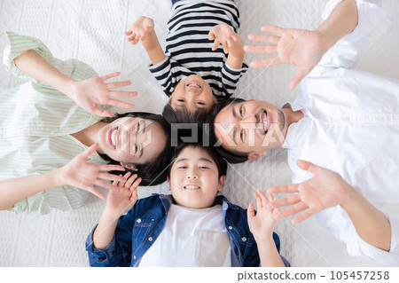Family portrait A family lying down with a smile Family portrait A family lying down with a smile 105457258